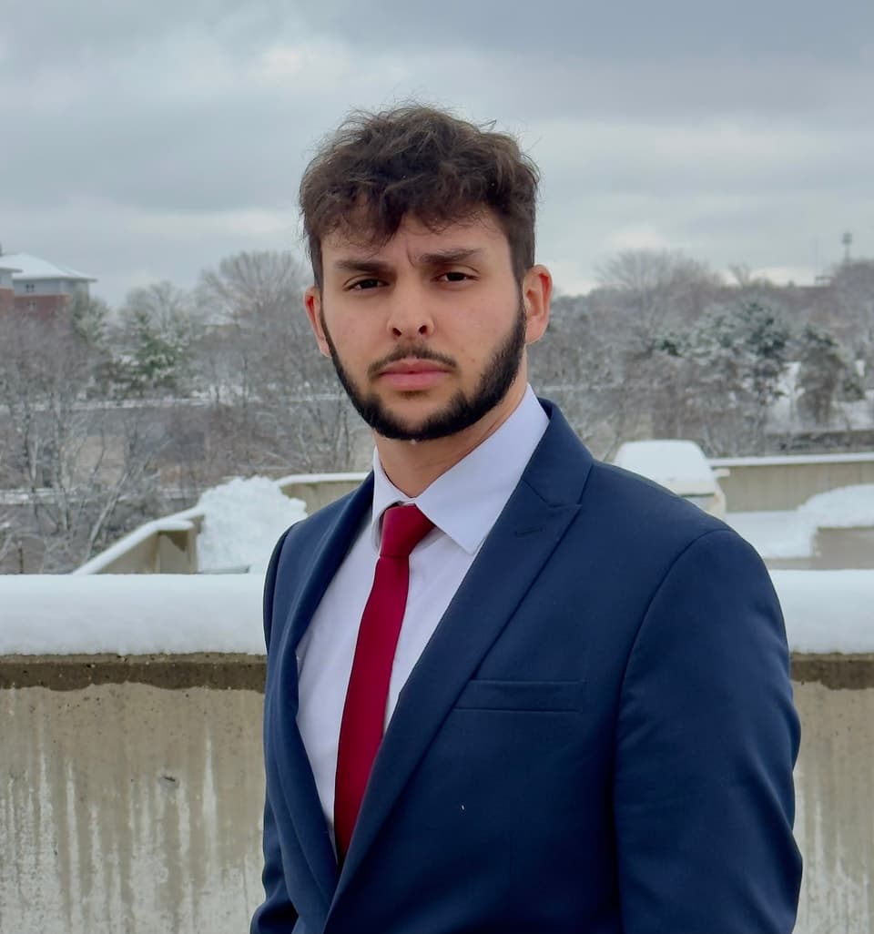 John V. Pereira in a suit outdoors